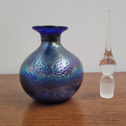 Stunning iridescent hand blown perfume bottle. Beautiful peacock blue, purple colours. Signed on base with clear glass stopper.