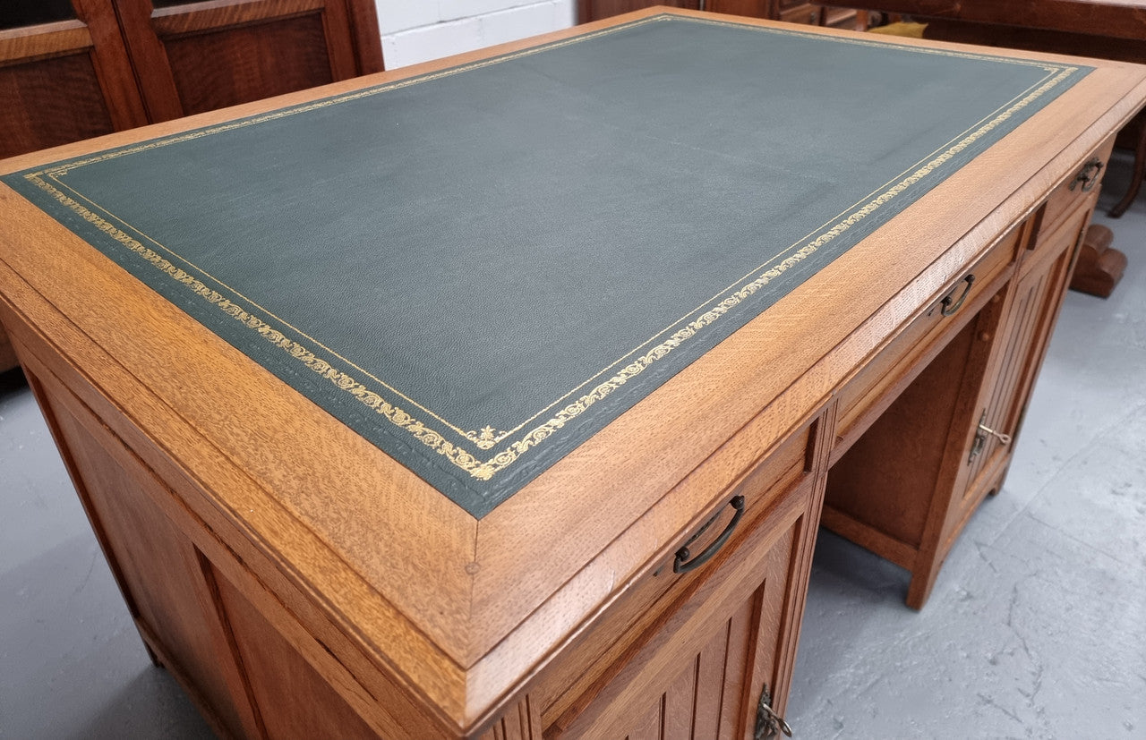 French Oak Art Deco full partners desk with leather top. Plenty of storage with both sides having three drawers at the top and two cupboards on both sides, one side has a filing section with three internal drawers and the other has a shelf on one side with three internal drawers as well. In good original detailed condition.