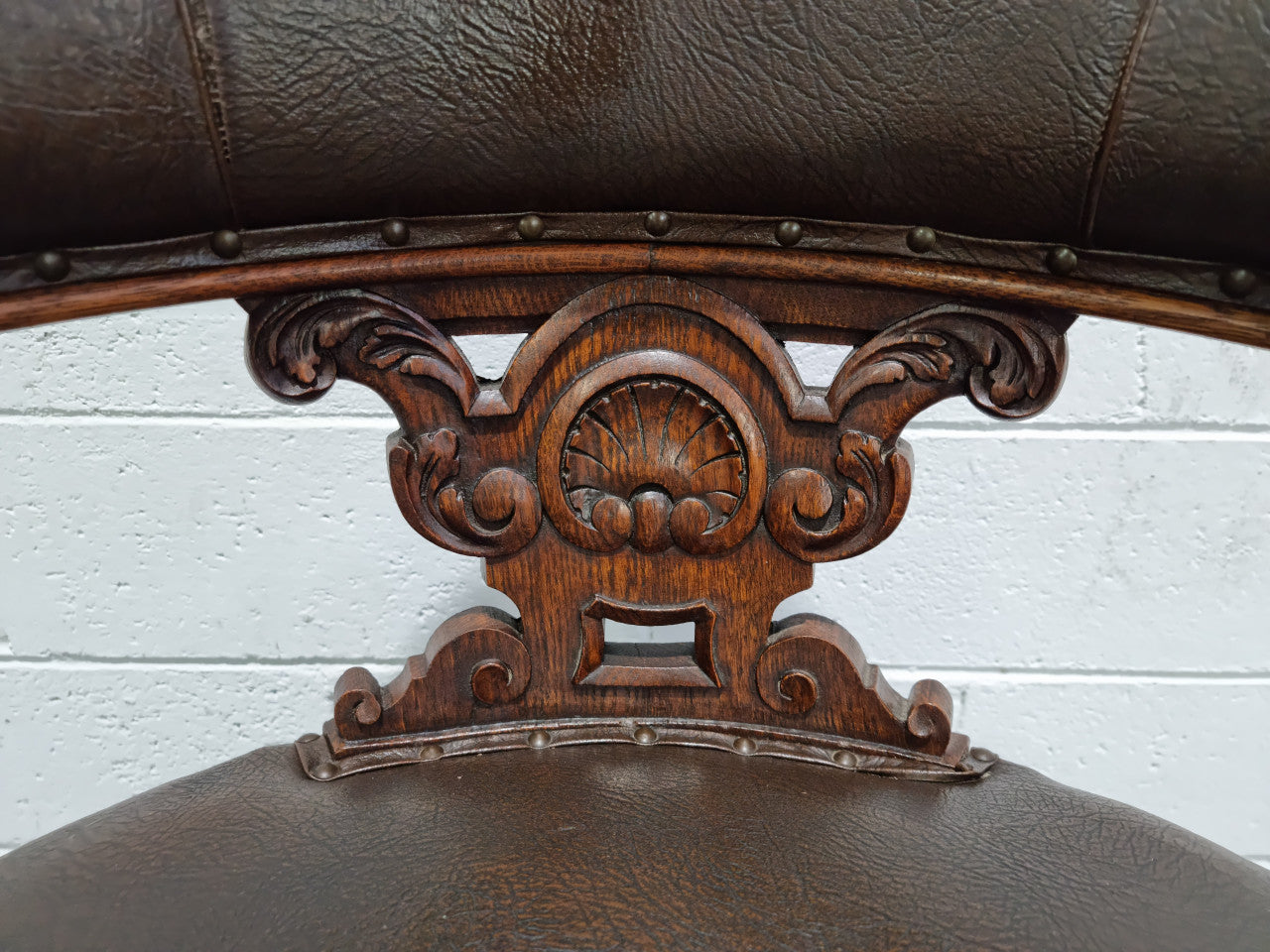 Henry 2nd style French Oak leather library chair with amazing detailed carvings. It is very comfortable to sit in and the leather is in good original condition.