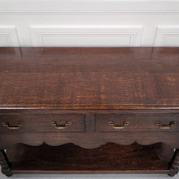 Rare size 19th Century English oak dresser base. It has two good size drawers and amazing patina. It has been sourced from France and in good original detailed condition.