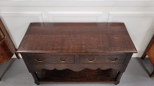 Rare size 19th Century English oak dresser base. It has two good size drawers and amazing patina. It has been sourced from France and in good original detailed condition.