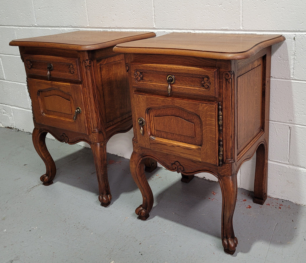 Pair of low Louis XV Style Oak bedsides with hard to find wooden tops. They are in good original detailed condition.