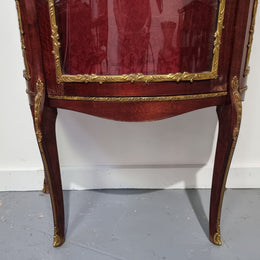 Louis XV style Walnut vitrine display cabinet with attractive ormolu mounts. Beautiful Maroon floral fabric backing with two glass shelves and cabriole legs with decorative ormolu mounts. In good original detailed condition.