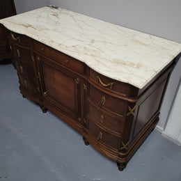 Fabulous French Walnut Louis XVI style cupboard, with a lovely marble top and nine drawers. There is also a cupboard and beautiful ormolu mounts. It is in good original detailed condition.