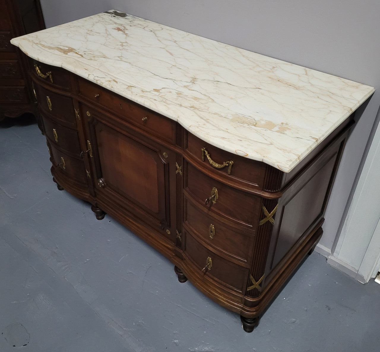 Fabulous French Walnut Louis XVI style cupboard, with a lovely marble top and nine drawers. There is also a cupboard and beautiful ormolu mounts. It is in good original detailed condition.