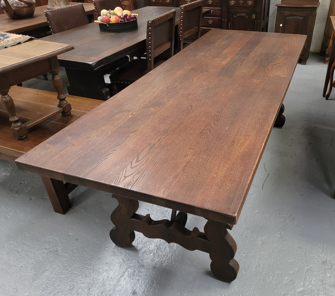 Spanish style French Oak farmhouse table with ironwork underneath. It is in good original detailed condition and has been sourced from France.