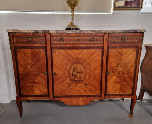 A high quality 19th Century French marquetry inlaid Kingwood marble top credenza. It has an attractive solid marble top and decorative marquetry inlay throughout. It has plenty of storage space with three drawers and three doors. It has been sourced from France and is in good original detailed condition.