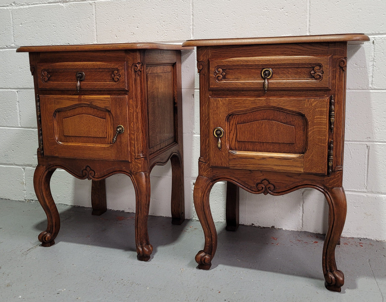 Pair of low Louis XV Style Oak bedsides with hard to find wooden tops. They are in good original detailed condition.