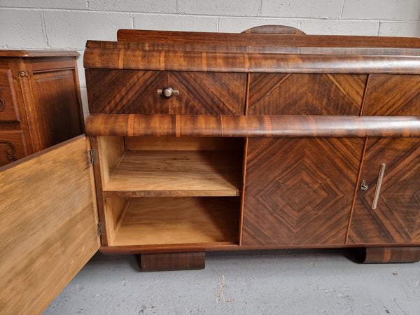 Vintage Walnut Art Deco “Waterfall” sideboard buffet with two drawers and two doors. It is in good original condition and has been sourced locally.