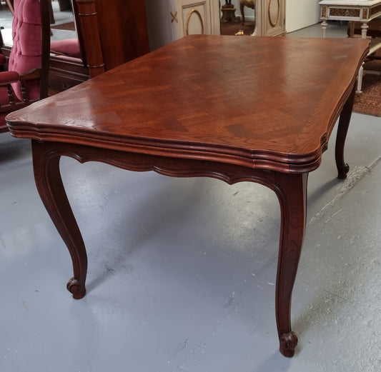 Beautiful French Oak Louis XV style parquetry top extension table. When fully extended the tables length is 239 cm. It is in good original detailed condition.