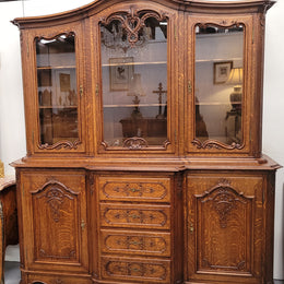 Impressive French Oak Louis 14th Style Display and Sideboard. It has 4 drawers, 2 bottom cupboards with 6 total shelves and 3 display doors with 3 shelves.  In good, detailed condition.