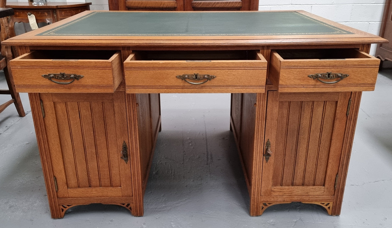 French Oak Art Deco full partners desk with leather top. Plenty of storage with both sides having three drawers at the top and two cupboards on both sides, one side has a filing section with three internal drawers and the other has a shelf on one side with three internal drawers as well. In good original detailed condition.