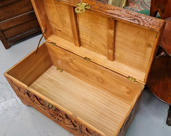 Vintage nicely carved Camphor wood chest. It has amazing carvings of boats, dragons and temples. It is in good original detailed condition.