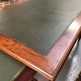 Lovely French Mahogany Louis XVI style leather top desk. With beautiful ormolu details and three drawers. There are also two slides on either side with tooled leather tops and in good original detailed condition.