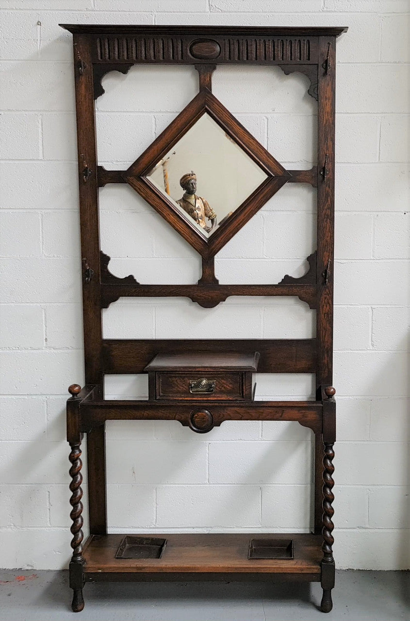 Beautiful Oak Antique Jacobean hall stand, with barley twist leg and a drawer for storage in very good original detailed condition condition.