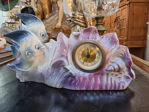 Vintage lustre ceramic fishes with clock. Featuring 2 fish and waves enclosing the clock. Not marked. Clock is ticking no guarantee.
