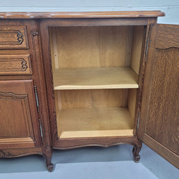 French Louis XV style parquetry top three door sideboard with two drawers. Plenty of storage space with a shelf behind each door. It is in good original detailed condition.