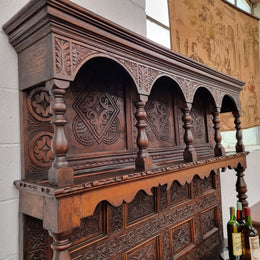 Impressively carved 18th Century English Oak kitchen dresser in 17th Century Jacobean style. It is in good original detailed condition and has been sourced from France.