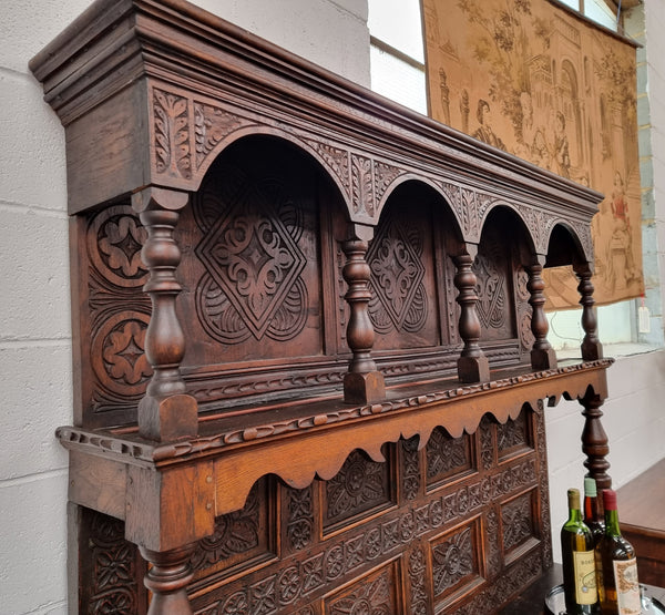 Impressively carved 18th Century English Oak kitchen dresser in 17th Century Jacobean style. It is in good original detailed condition and has been sourced from France.