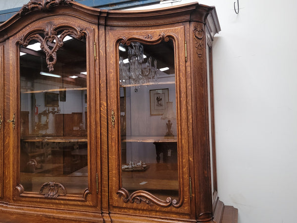 Impressive French Oak Louis 14th Style Display and Sideboard. It has 4 drawers, 2 bottom cupboards with 6 total shelves and 3 display doors with 3 shelves.  In good, detailed condition.