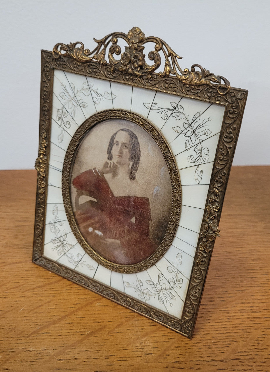 Hand coloured early photo of women in a stunning frame with paino key surround and detailed gilded metal frame.
