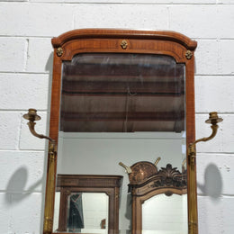 Decorative late 19th Century mahogany French wall mirror with brass swivel candle holders and brass detail. In good original detailed condition.