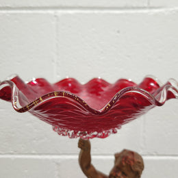 Late Victorian spelter table centerpiece/comfort featuring putti holding ruby glass bowl. In good original condition with no damage to the glass.