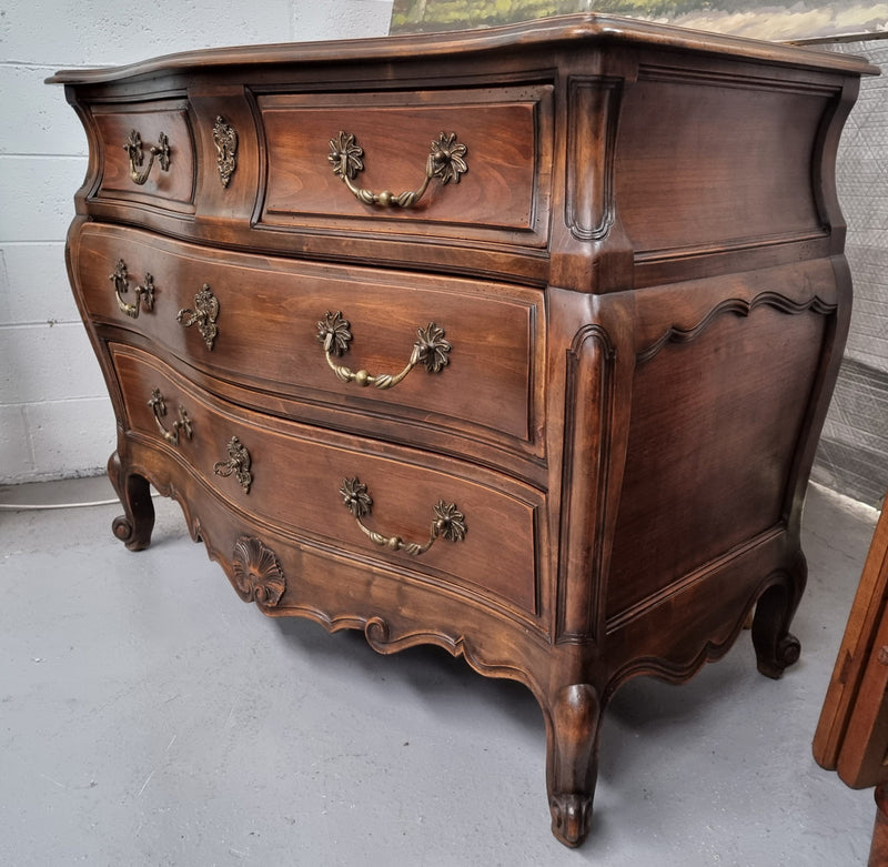Impressive French Louis XV style Cherrywood four drawer commode, with a wooden top, two large drawers and two smaller drawers. Features attractive handles and a carved skirt and feet. In good original detailed condition.