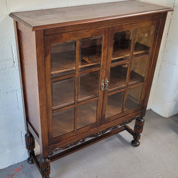 Tudor oak 2 door astral glaze and beveled glass bookcase.  Good original condition. Circa 1930s.