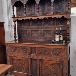 Impressively carved 18th Century English Oak kitchen dresser in 17th Century Jacobean style. It is in good original detailed condition and has been sourced from France.