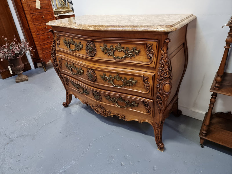 Impressive Louis XV style three drawer walnut commode. Ormolu handles and bevelled marble top complimenting detailed carving. In very good original detailed condition.