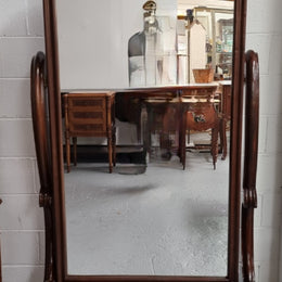 Antique Victorian 19th Century full length Mahogany cheval mirror. Mirror supported on two elegant scrolled upright support and stands on moulded base with four scrolled feet and castors.