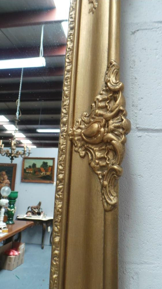 A French transitional Louis XV/Louis XVI style, gilded hanging wall mirror. In good restored condition.