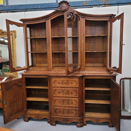 Impressive French Oak Louis 14th Style Display and Sideboard. It has 4 drawers, 2 bottom cupboards with 6 total shelves and 3 display doors with 3 shelves.  In good, detailed condition.