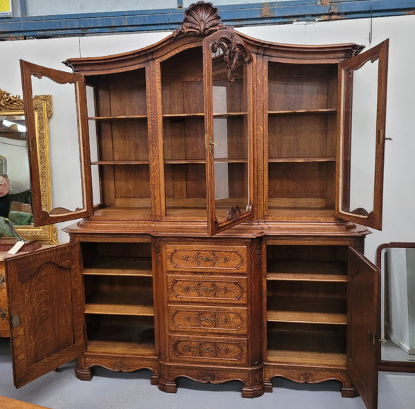 Impressive French Oak Louis 14th Style Display and Sideboard. It has 4 drawers, 2 bottom cupboards with 6 total shelves and 3 display doors with 3 shelves.  In good, detailed condition.
