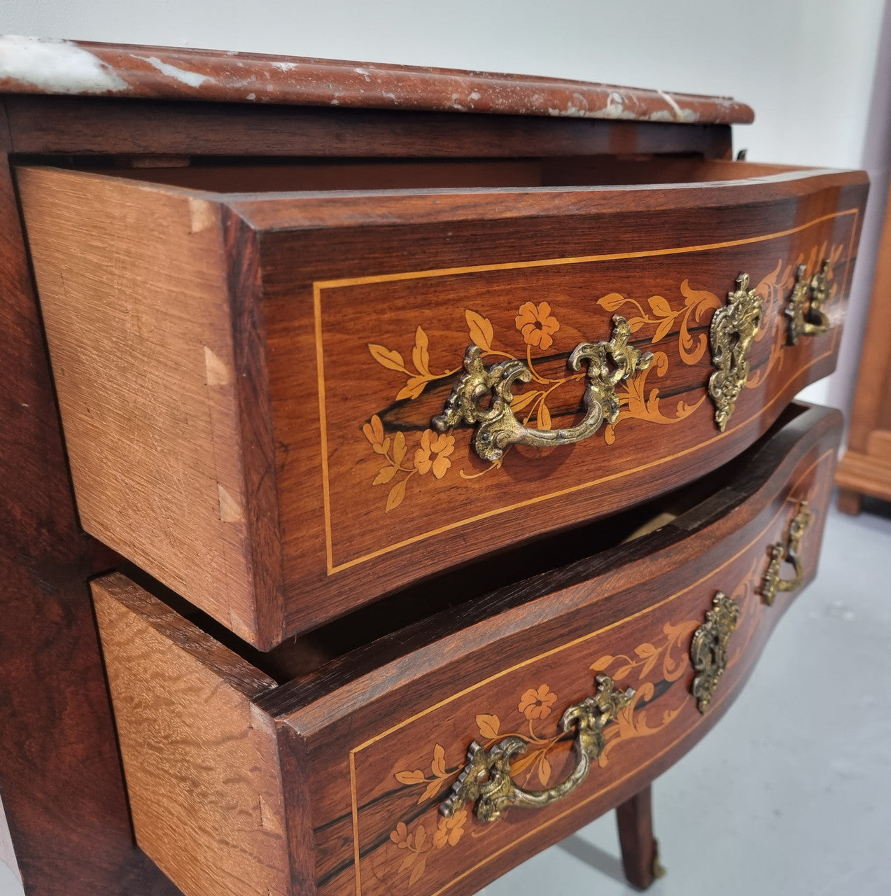 A stunning French petite two drawer inlaid Rosewood commode. In good original detailed condition.