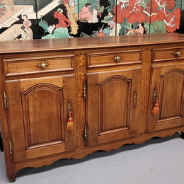 French Oak early 19th century three door buffet. It has a classic simple look and has three cupboards and three drawers. It is in good original detailed condition.