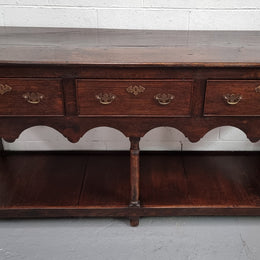 Antique 19th Century English dark Oak three drawer Dresser with brass handles and in good original condition.