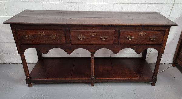 Antique 19th Century English dark Oak three drawer Dresser with brass handles and in good original condition.