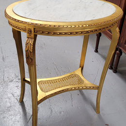 Impressive French oval Louis XVI style gilt and white marble topped two tier lamp/side table. It has been sourced from France and is in good original detailed condition.