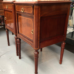 A lovely French inlaid pair of flame mahogany bedside cabinets with ormolu and in good condition.