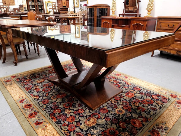 French Art Deco Figured Walnut dining table and six chairs. This stylish table also comes with a glass top and can be used with or without it. The chairs are very comfortable and the table can also fit another two chairs at either end making it a 6-8 seater. The table is in good original detailed condition with character marks to the top of table as shown in the pictures. This table and six chairs have been sourced locally.