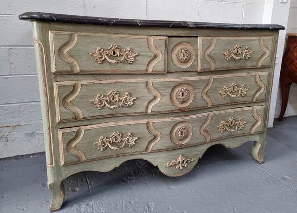 Early 19th Century Louis XIV style faux marble top and painted base commode. It is of large proportions and has four drawers. In good original detailed condition.