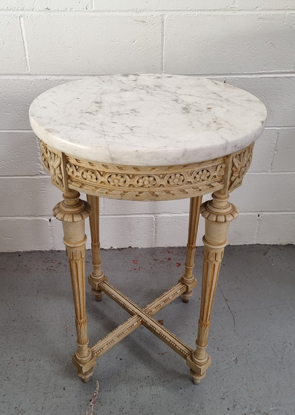 Louis XVI style round side table with original paint and a beautiful thick marble top. It is in good original detailed condition.