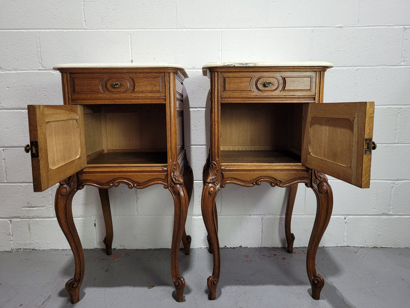 Pair of Louis XV style bedside cabinets with beautiful marble tops and one drawer and single cupboard for all your storage needs. In good original detailed condition.