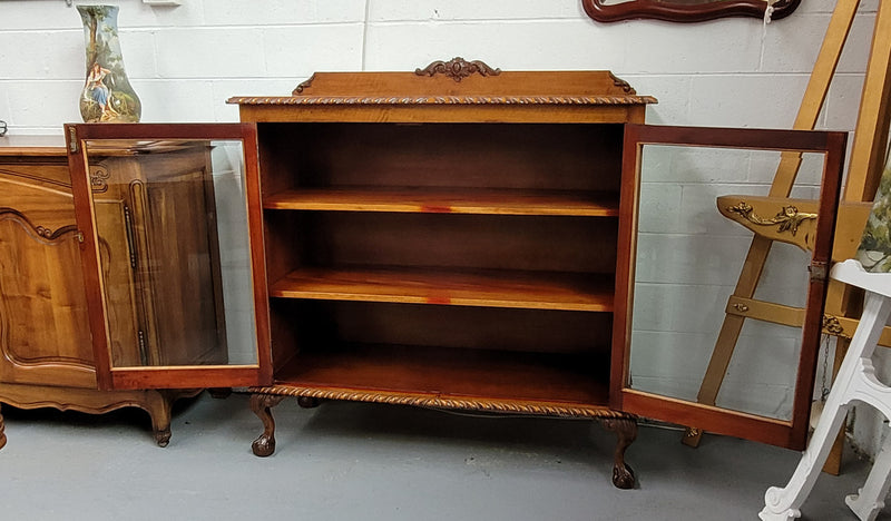 Chippendale style Mahogany two door bookcase. It has bevelled glass doors and two adjustable shelves. It has been sourced locally and is in good original detailed condition.