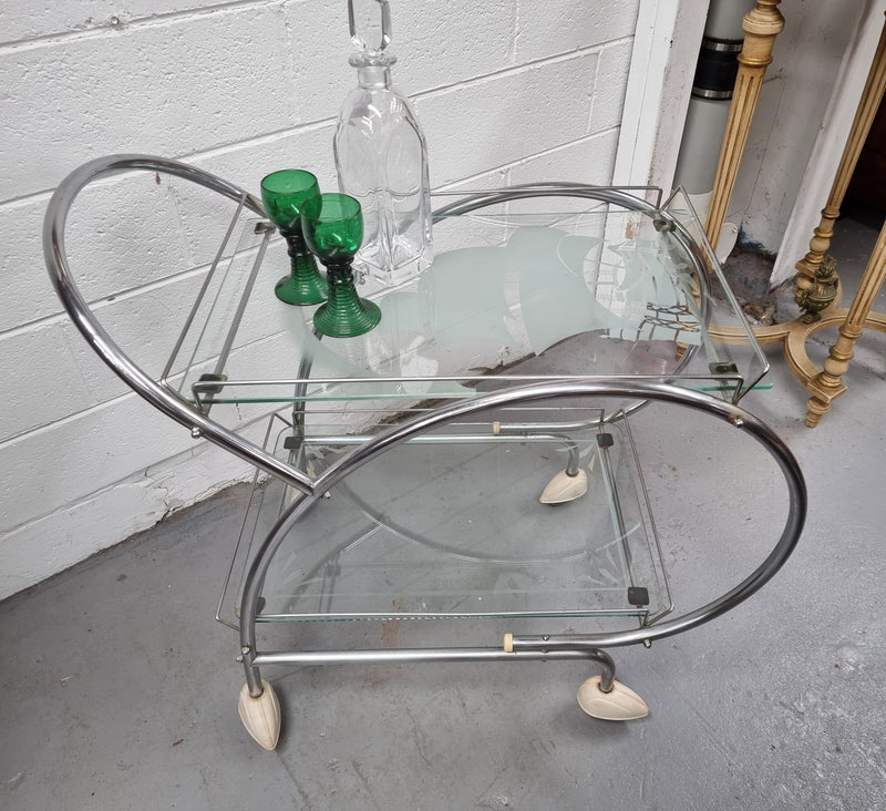 Stylish Art Deco chrome & frosted glass drinks trolley. Bakelite guards on the wheels. It is in good original condition and has been sourced locally.