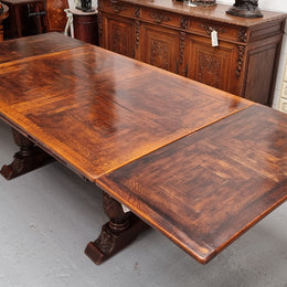 Renaissance style Oak extension table with parquetry top and twin pedestal base. The table extends by pulling out an extension leaf either side making it 287 cm long. Sourced from France and in good original detailed condition.