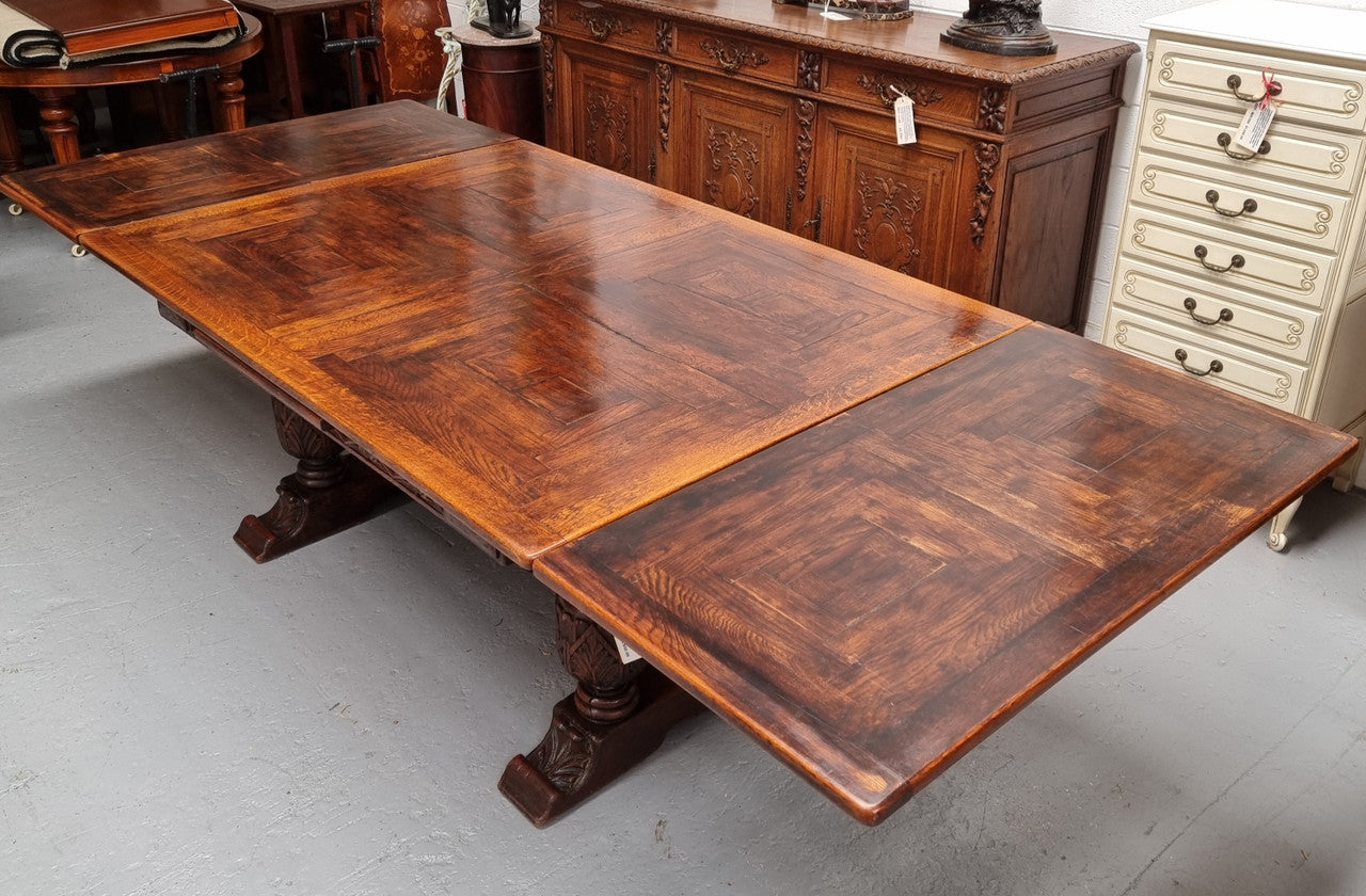 Renaissance style Oak extension table with parquetry top and twin pedestal base. The table extends by pulling out an extension leaf either side making it 287 cm long. Sourced from France and in good original detailed condition.