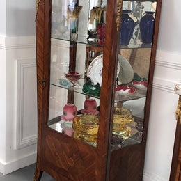 A Louis XV style Kingwood vitrine with marble top. It has beautifully floral inlay with ormolu mounts.